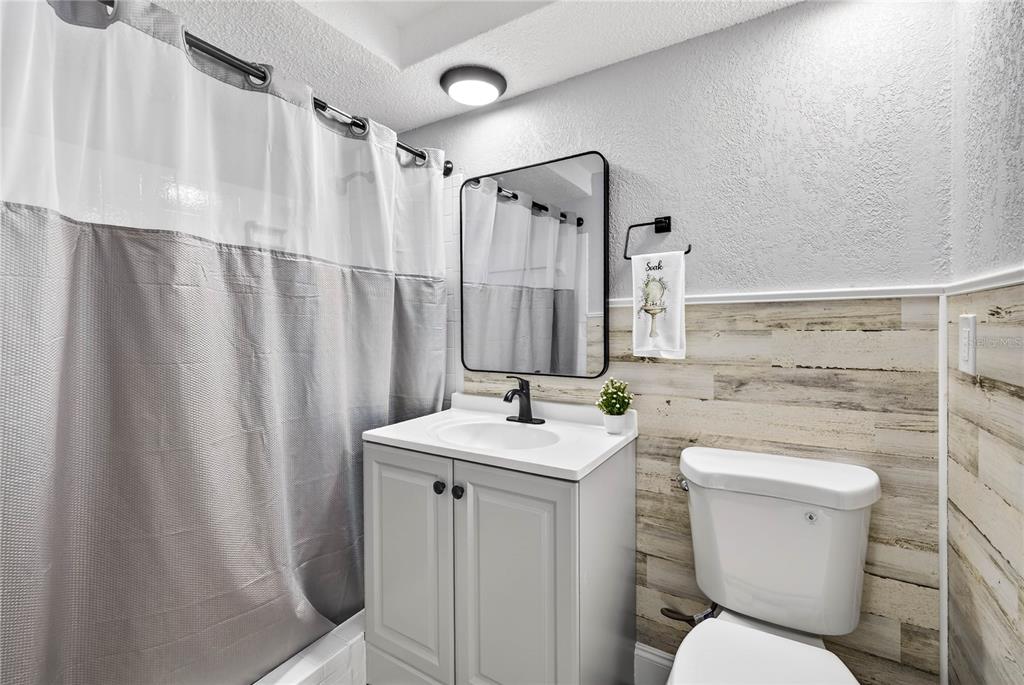 11214 Kapok Avenue Port Richey, FL 34668 - Photo 21 of 25 a bathroom with toilet sink and mirror