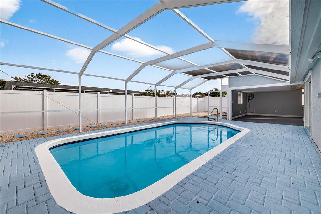 11214 Kapok Avenue Port Richey, FL 34668 - Photo 24 of 25 a view of a swimming pool with a chair