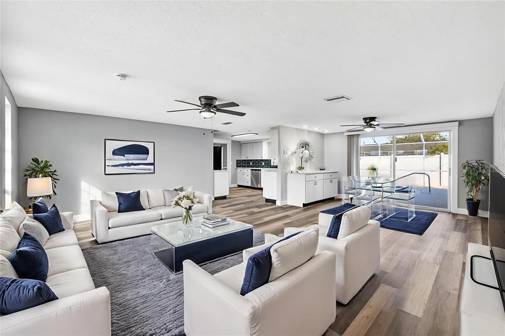 11214 Kapok Avenue Port Richey, FL 34668 - Photo 5 of 25 a living room with furniture wooden floor and a large window