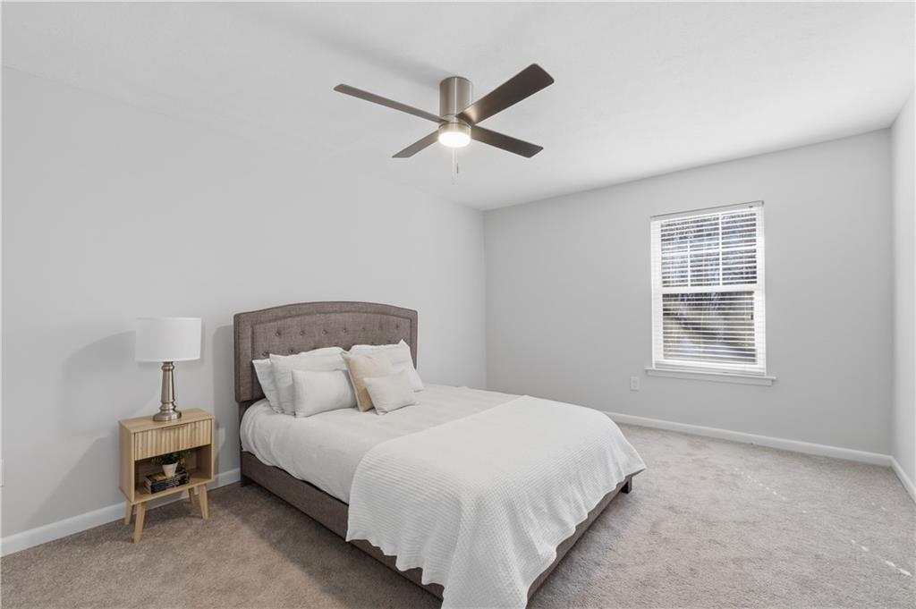 1150 Collier Road Northwest, Unit 6H Atlanta, GA 30318 - Photo 15 of 29 a bedroom with a bed and window