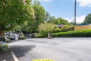 1150 Collier Road Northwest, Unit 6H Atlanta, GA 30318 - Photo 27 of 29 a view of a parked cars in front of a building