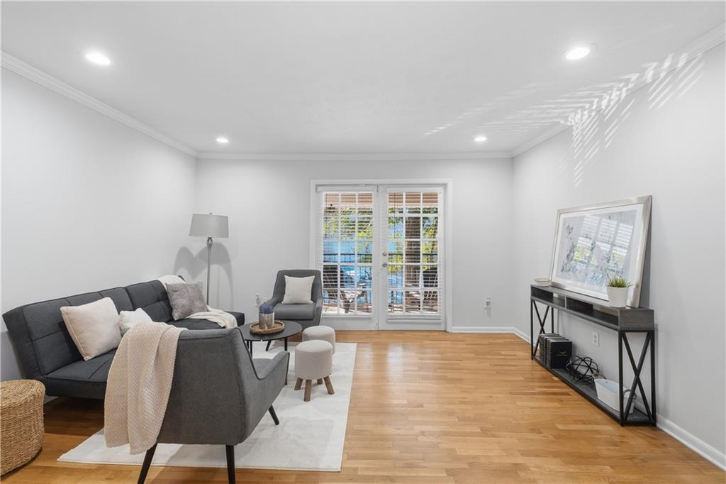 1150 Collier Road Northwest, Unit 6H Atlanta, GA 30318 - Photo 3 of 29 a living room with furniture and a wooden floor
