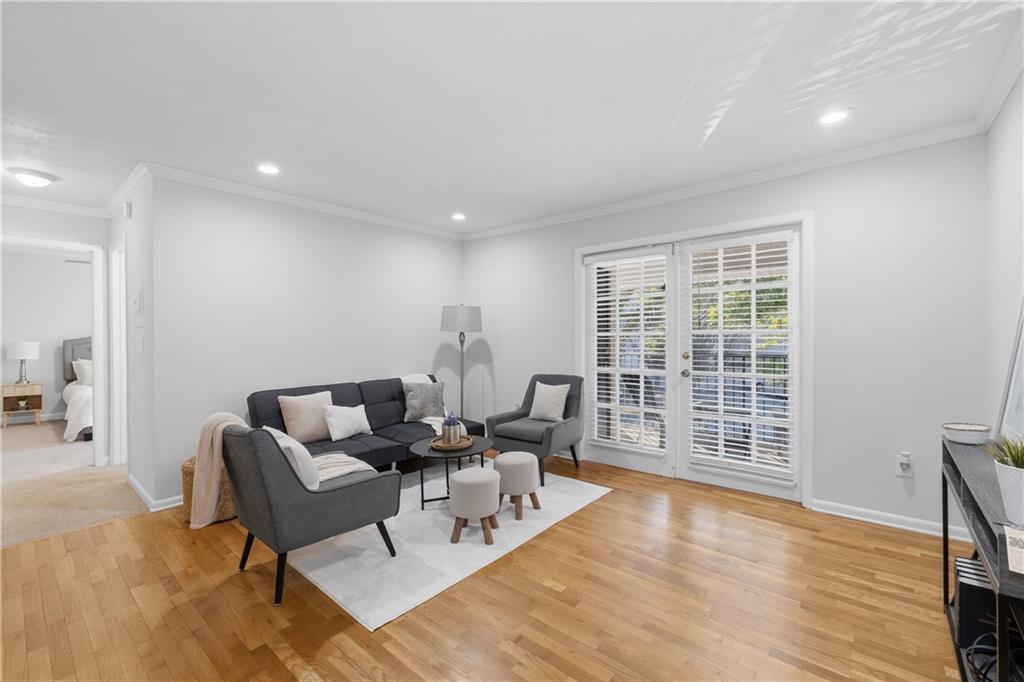 1150 Collier Road Northwest, Unit 6H Atlanta, GA 30318 - Photo 4 of 29 a living room with furniture and a large window