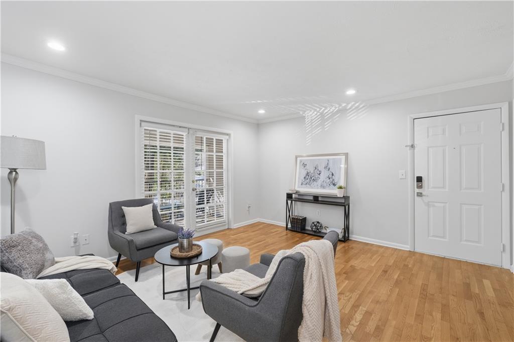 1150 Collier Road Northwest, Unit 6H Atlanta, GA 30318 - Photo 7 of 29 a bedroom with furniture and a window