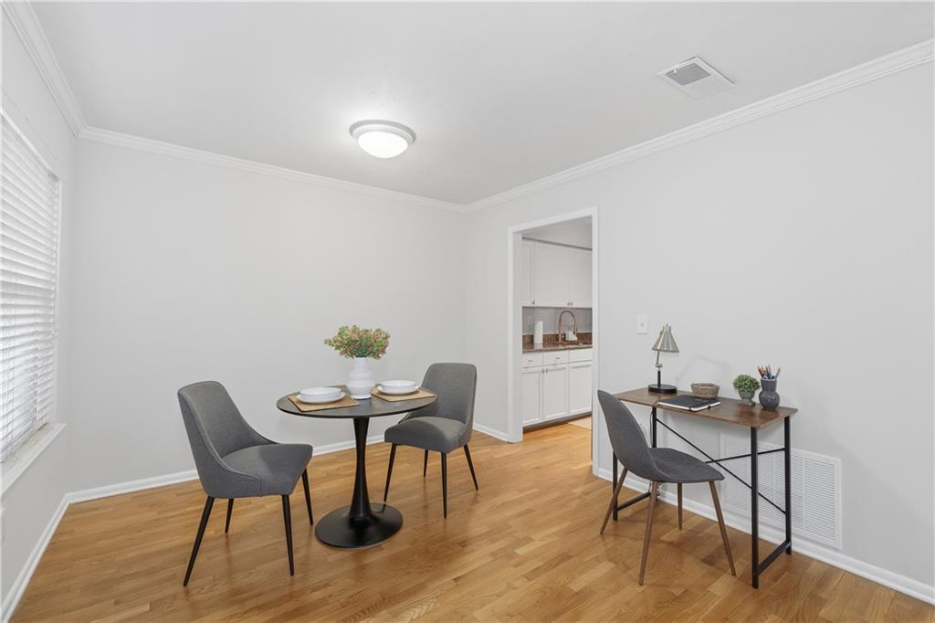 1150 Collier Road Northwest, Unit 6H Atlanta, GA 30318 - Photo 8 of 29 a view of a workspace with furniture and wooden floor
