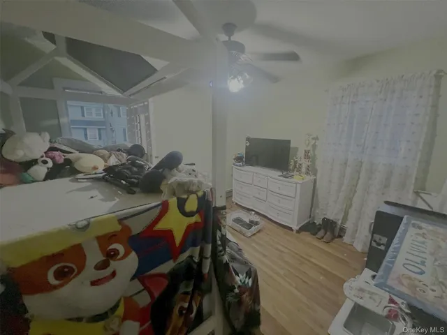 a bedroom with furniture and a wooden floor