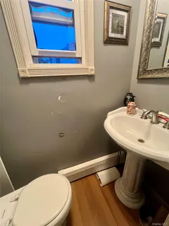 a bathroom with a sink mirror and toilet