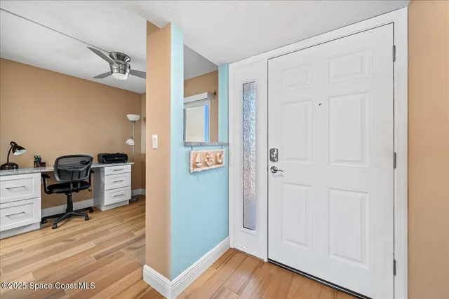 a view of a workspace with wooden floor and bathroom