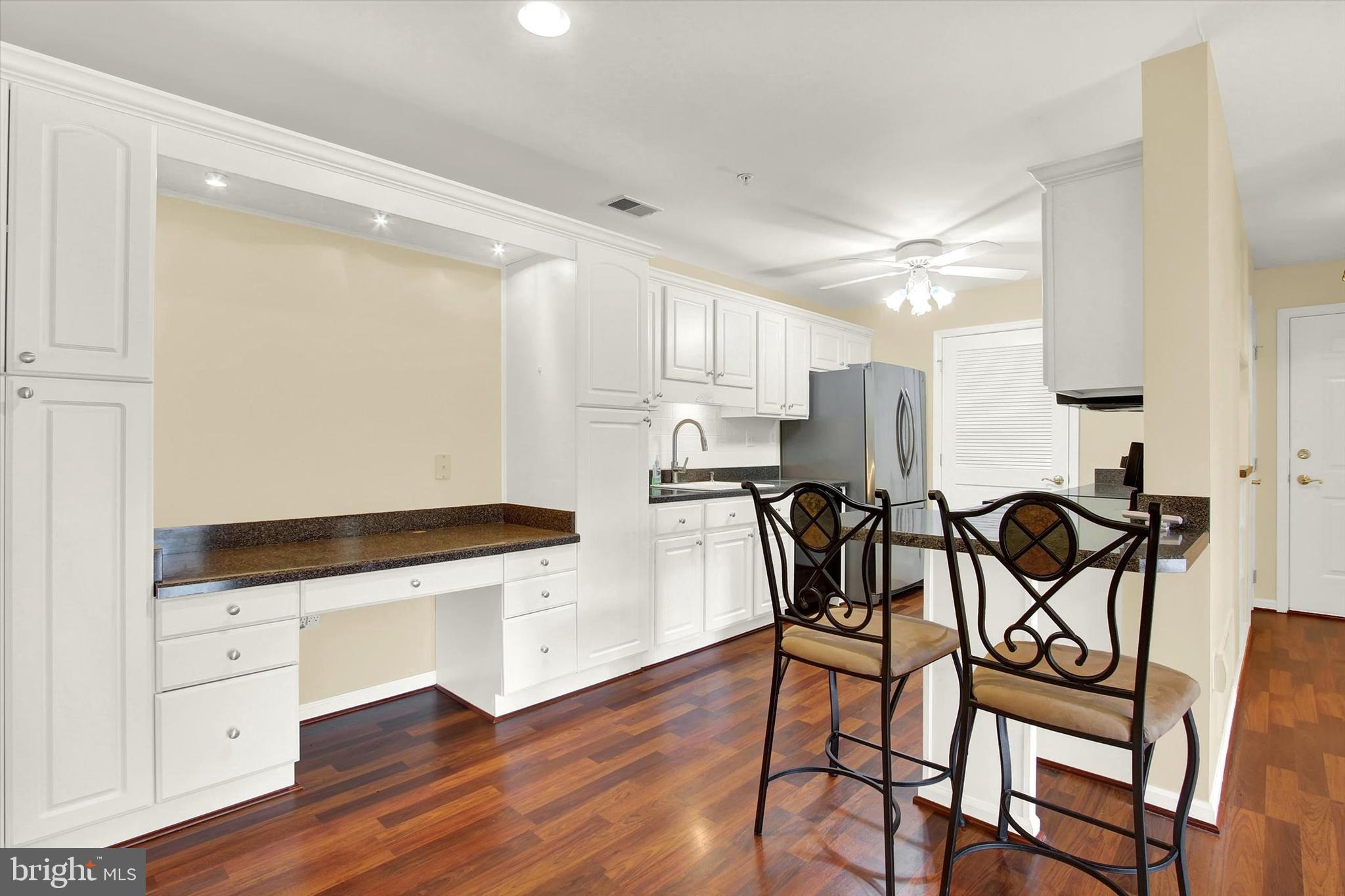 6500 Ridenour Way East, Unit 3C Sykesville, MD 21784 - Photo 13 of 22 a kitchen with granite countertop white cabinets and appliances