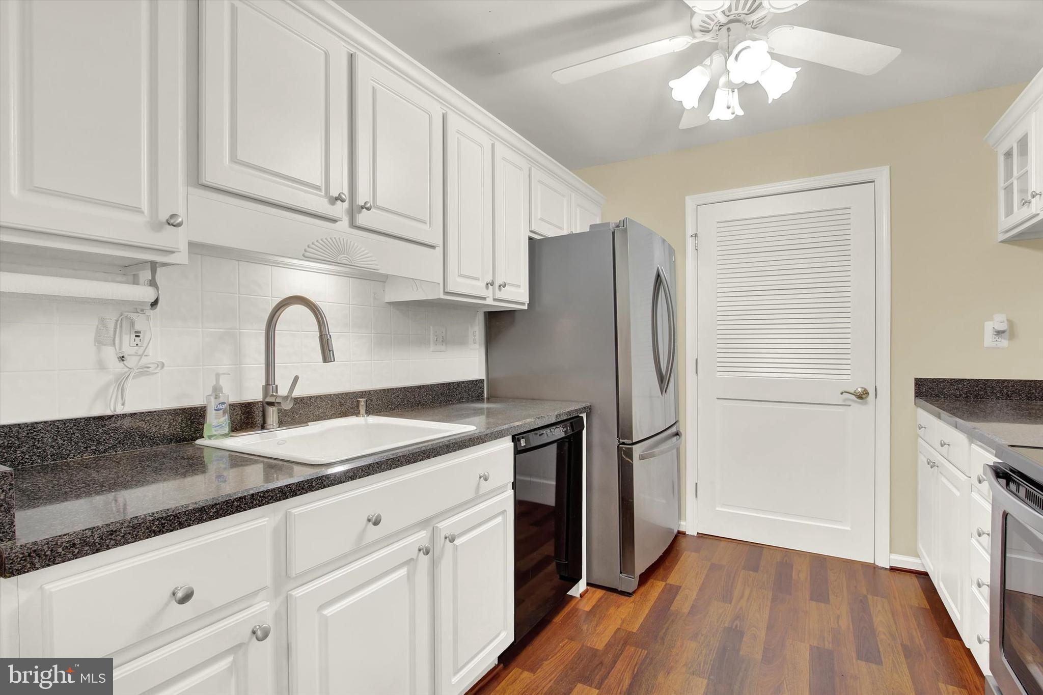 6500 Ridenour Way East, Unit 3C Sykesville, MD 21784 - Photo 6 of 22 a kitchen with granite countertop white cabinets and stainless steel appliances
