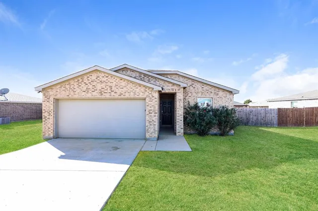 a view of a house with a yard and garage