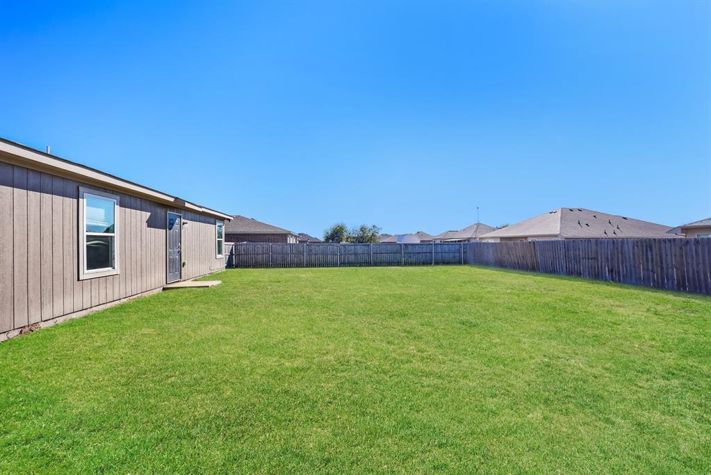 2712 William Street Mabank, TX 75147 - Photo 19 of 20 a view of a back yard of the house with a big yard
