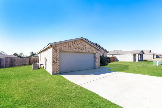 a view of a house with a yard and garage