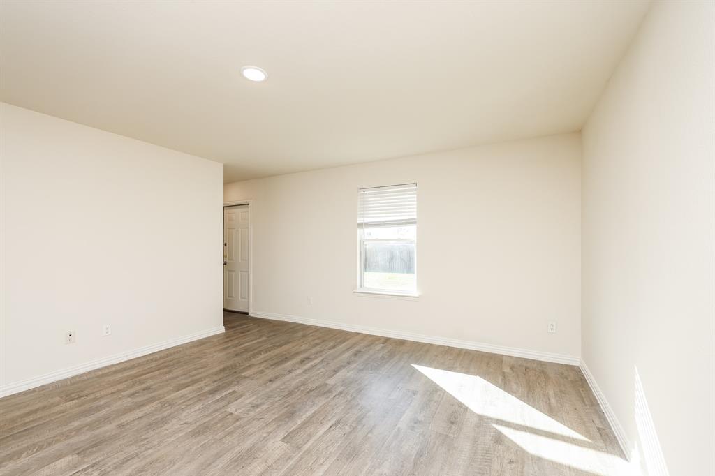 2712 William Street Mabank, TX 75147 - Photo 5 of 20 an empty room with wooden floor and windows