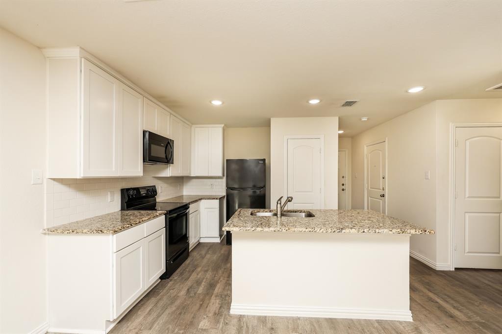 2712 William Street Mabank, TX 75147 - Photo 7 of 20 a kitchen with a sink stove and refrigerator