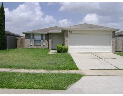 a front view of a house with a garden and yard