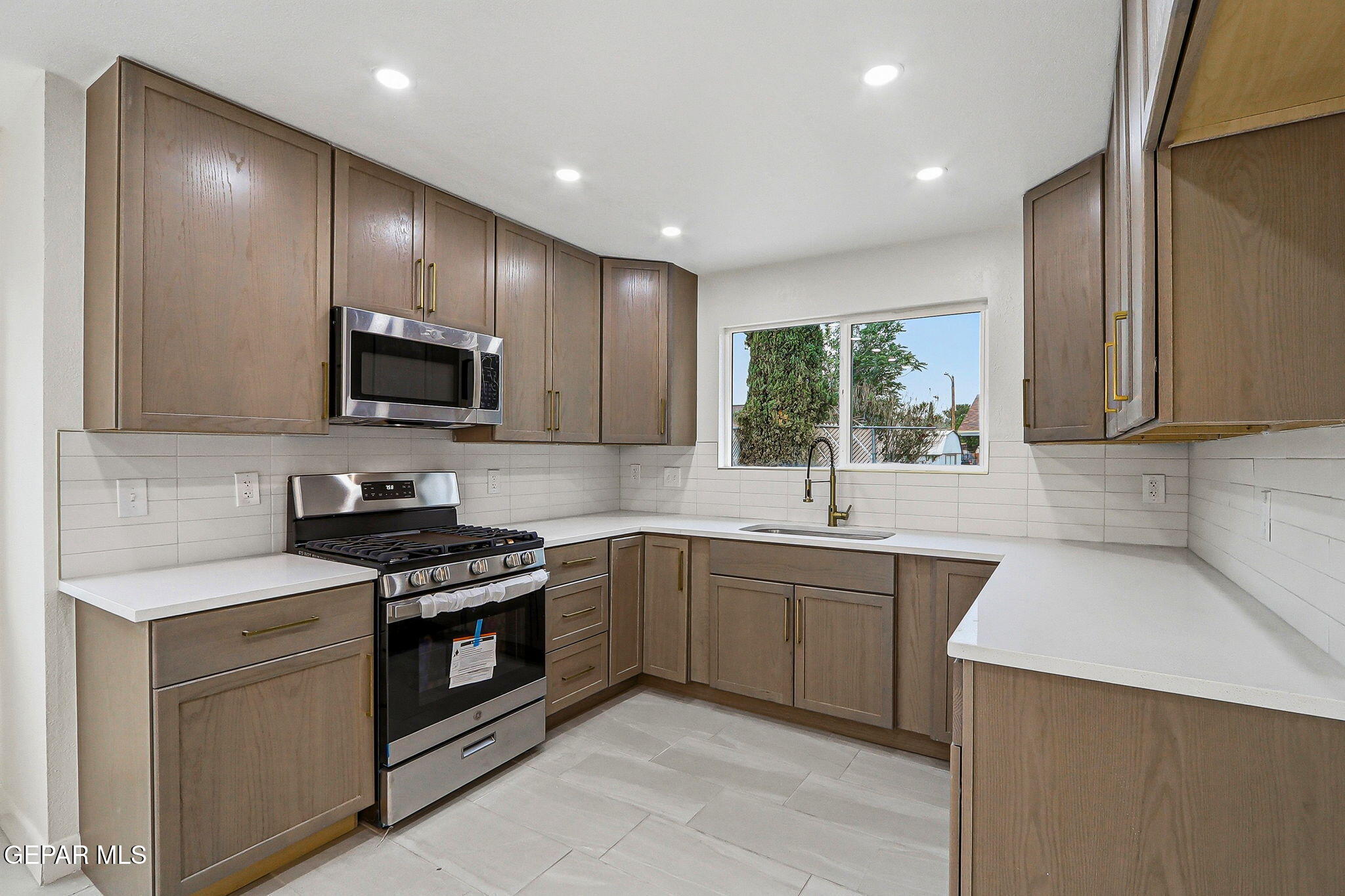 709 Frontera Road El Paso, TX 79922 - Photo 12 of 41 a kitchen with stainless steel appliances a sink stove and microwave