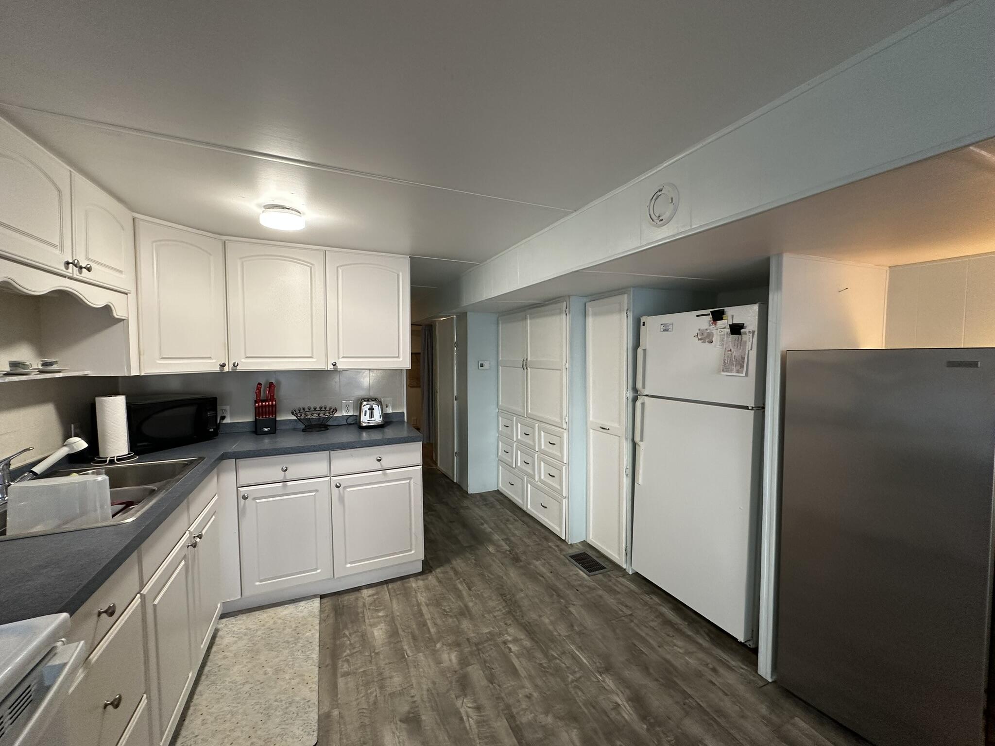 65821 Overseas Highway, Unit 310 Long Key, FL 33001 - Photo 12 of 32 a kitchen with a refrigerator a stove top oven a sink and cabinets
