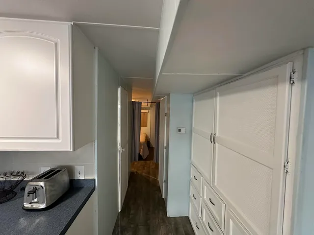 a hallway with front door wooden floor and stairs