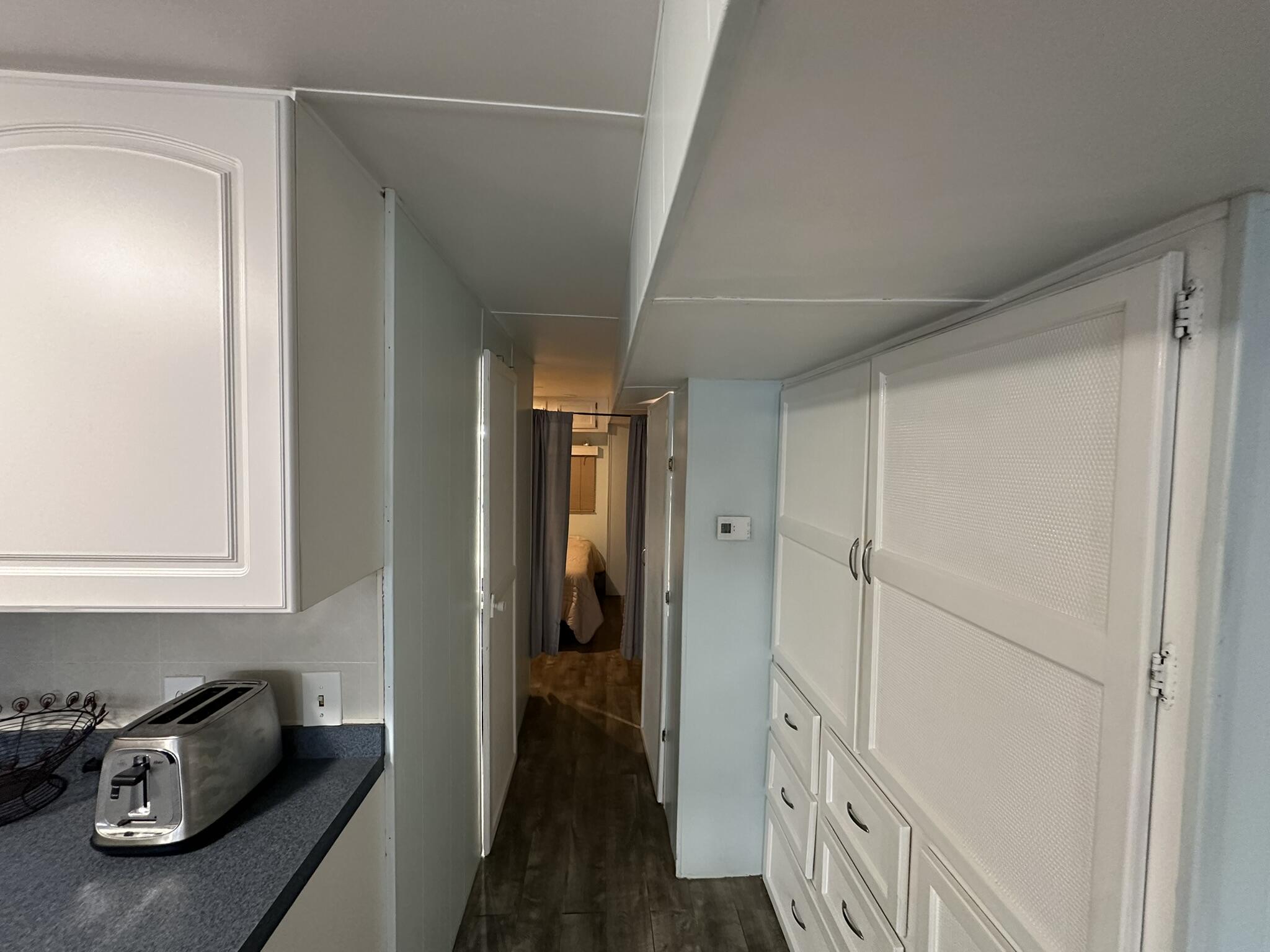 65821 Overseas Highway, Unit 310 Long Key, FL 33001 - Photo 18 of 32 a hallway with front door wooden floor and stairs