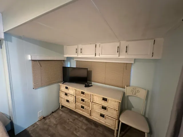 a kitchen with stainless steel appliances a microwave a stove and white cabinets