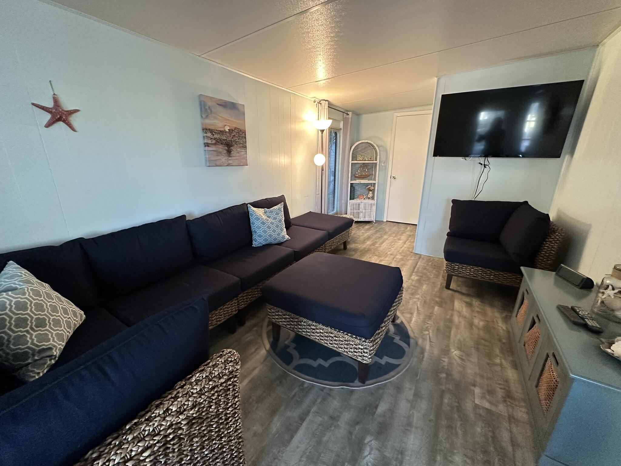 65821 Overseas Highway, Unit 310 Long Key, FL 33001 - Photo 3 of 32 a living room with furniture and a flat screen tv