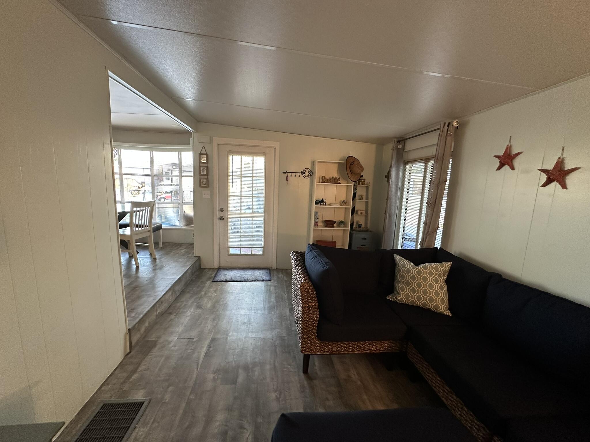 65821 Overseas Highway, Unit 310 Long Key, FL 33001 - Photo 8 of 32 a living room with furniture and wooden floor
