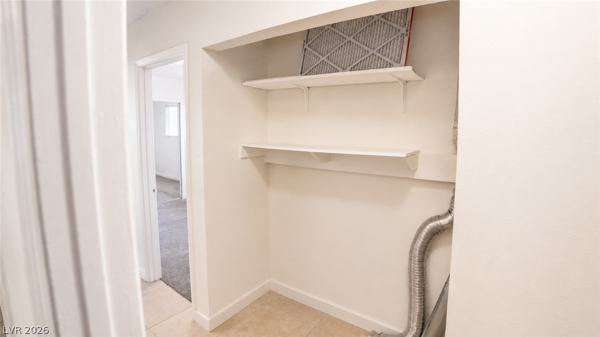 2870 South Sandhill Road Las Vegas, NV 89121 - Photo 46 of 64 Ample shelving in this dedicated laundry space offers practical storage solutions.
