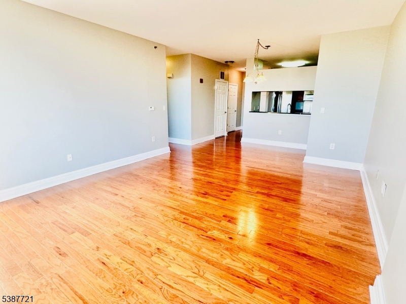 1806 One Spring Street, Unit 1806 New Brunswick, NJ 08901 - Photo 12 of 49 a view of a living room with furniture and wooden floor