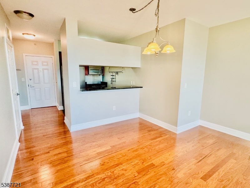 1806 One Spring Street, Unit 1806 New Brunswick, NJ 08901 - Photo 20 of 49 a view of a kitchen with wooden floor and a ceiling fan