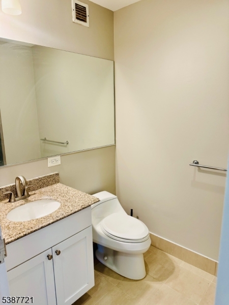 1806 One Spring Street, Unit 1806 New Brunswick, NJ 08901 - Photo 24 of 49 a bathroom with a granite countertop toilet and a sink