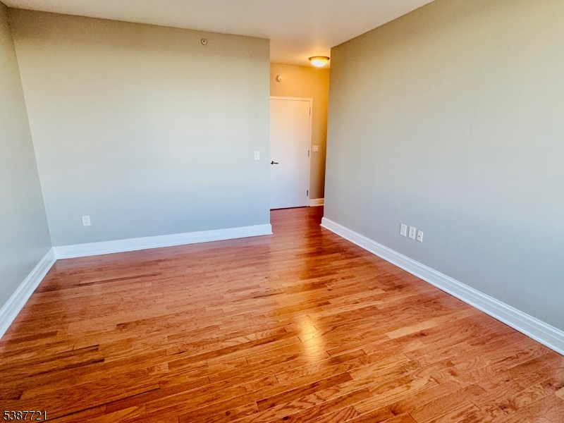 1806 One Spring Street, Unit 1806 New Brunswick, NJ 08901 - Photo 27 of 49 a view of an empty room with wooden floor