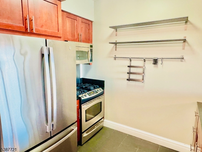 1806 One Spring Street, Unit 1806 New Brunswick, NJ 08901 - Photo 5 of 49 a kitchen with stainless steel appliances a refrigerator and a stove