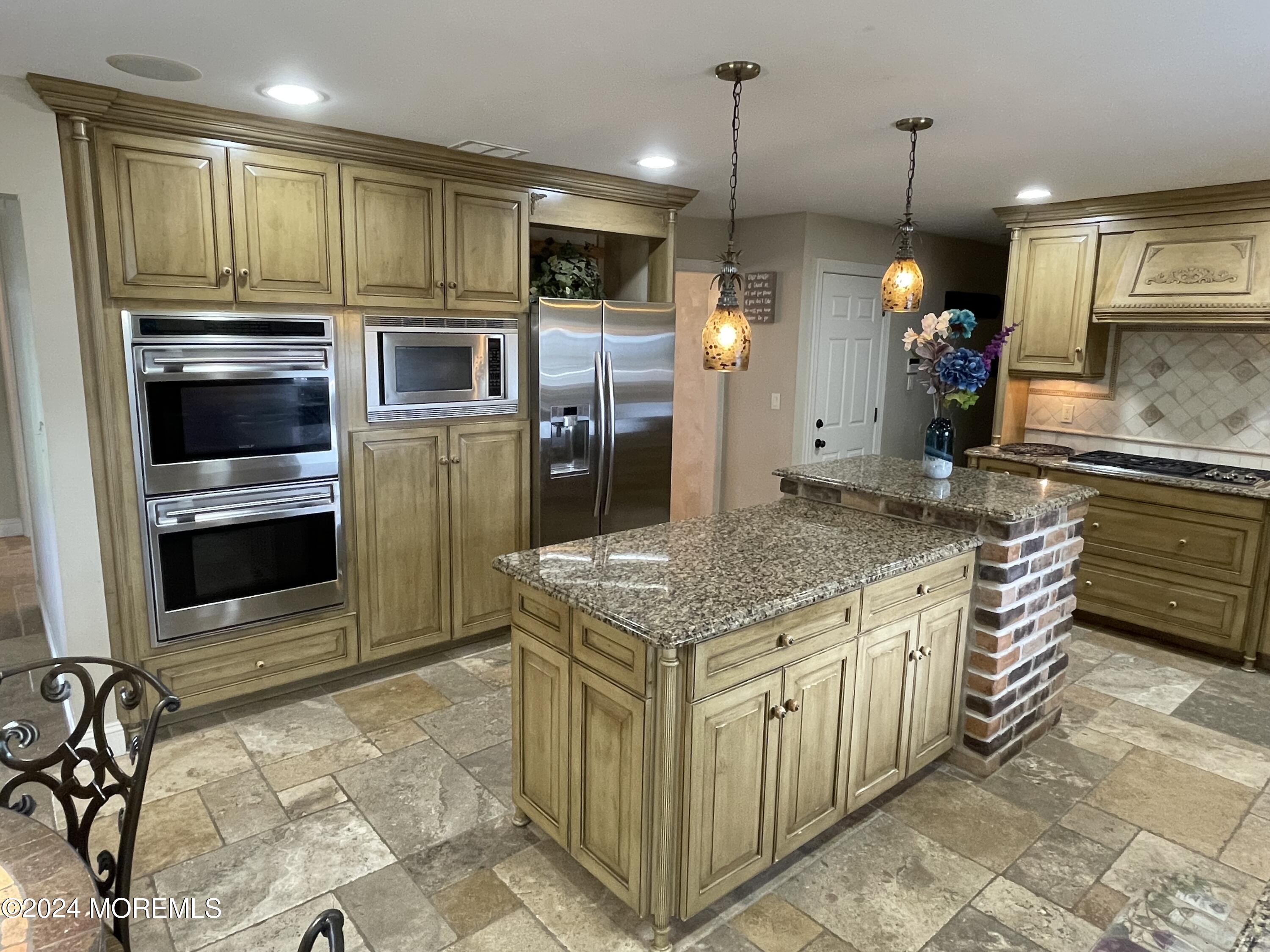 1 Longstreet Road Manalapan, NJ 07726 - Photo 12 of 76 a kitchen with stainless steel appliances kitchen island granite countertop a stove refrigerator and microwave