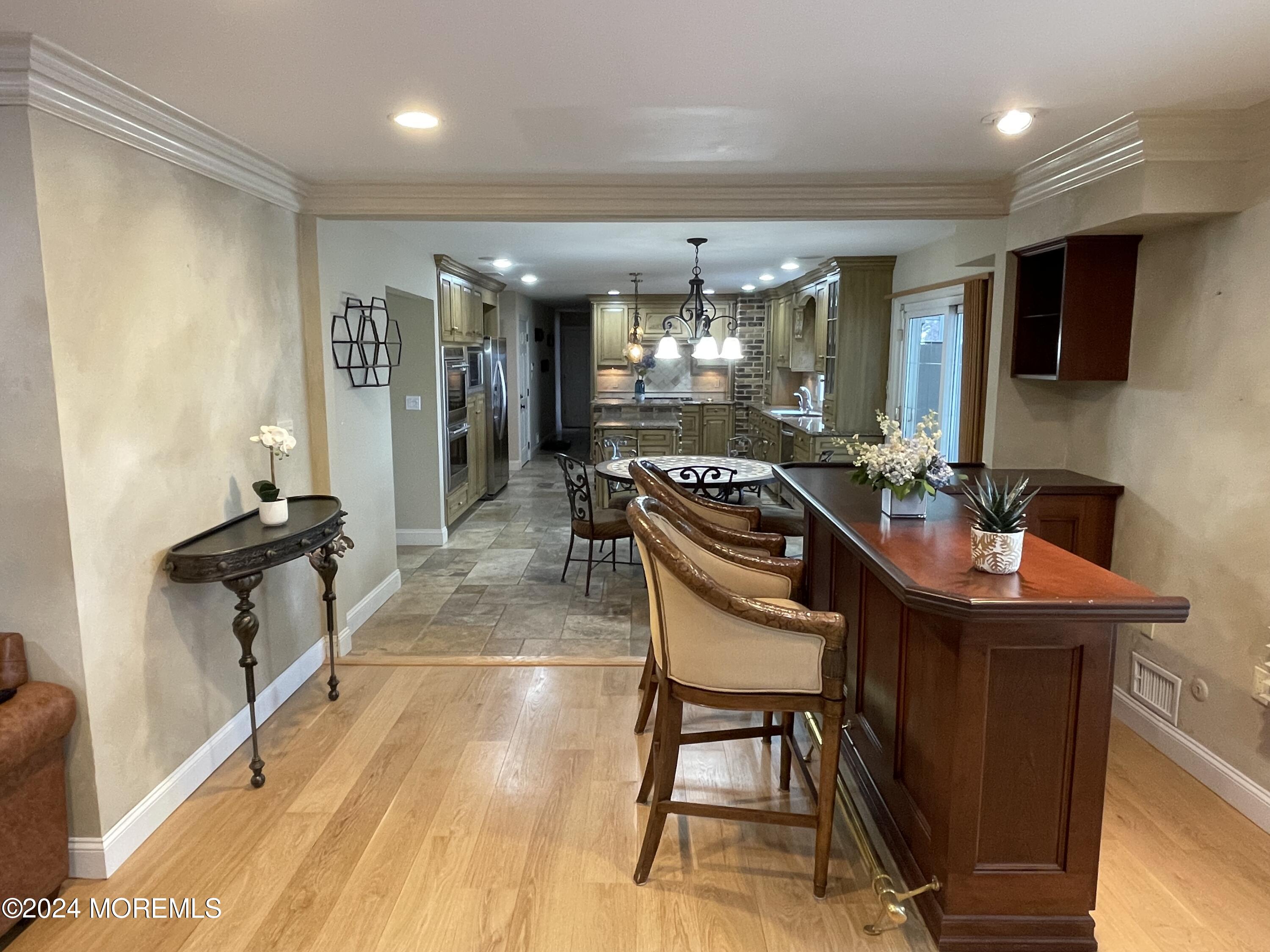 1 Longstreet Road Manalapan, NJ 07726 - Photo 14 of 76 a room with furniture a flat screen tv and a table