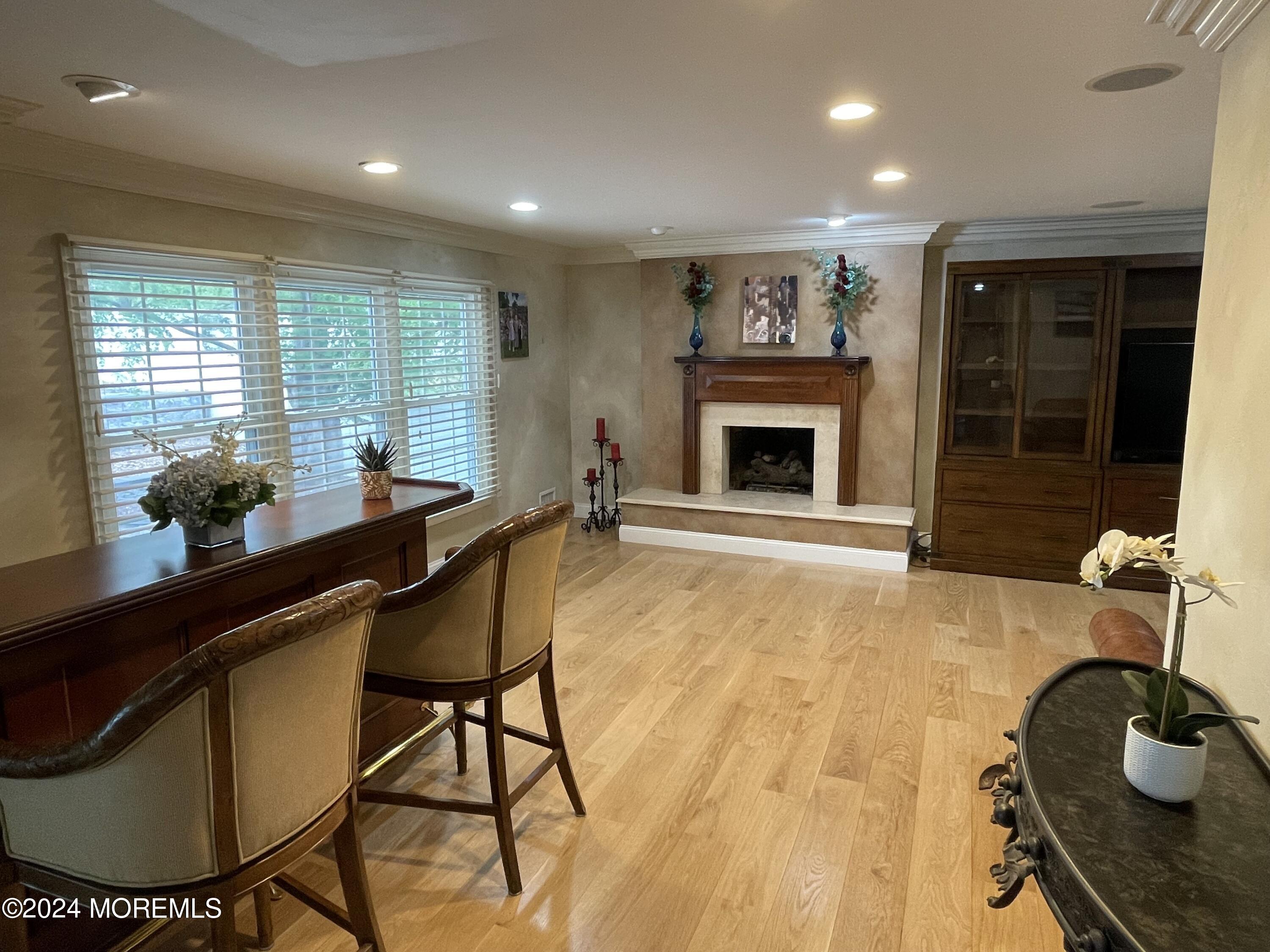 1 Longstreet Road Manalapan, NJ 07726 - Photo 16 of 76 a dining room with furniture and a fireplace