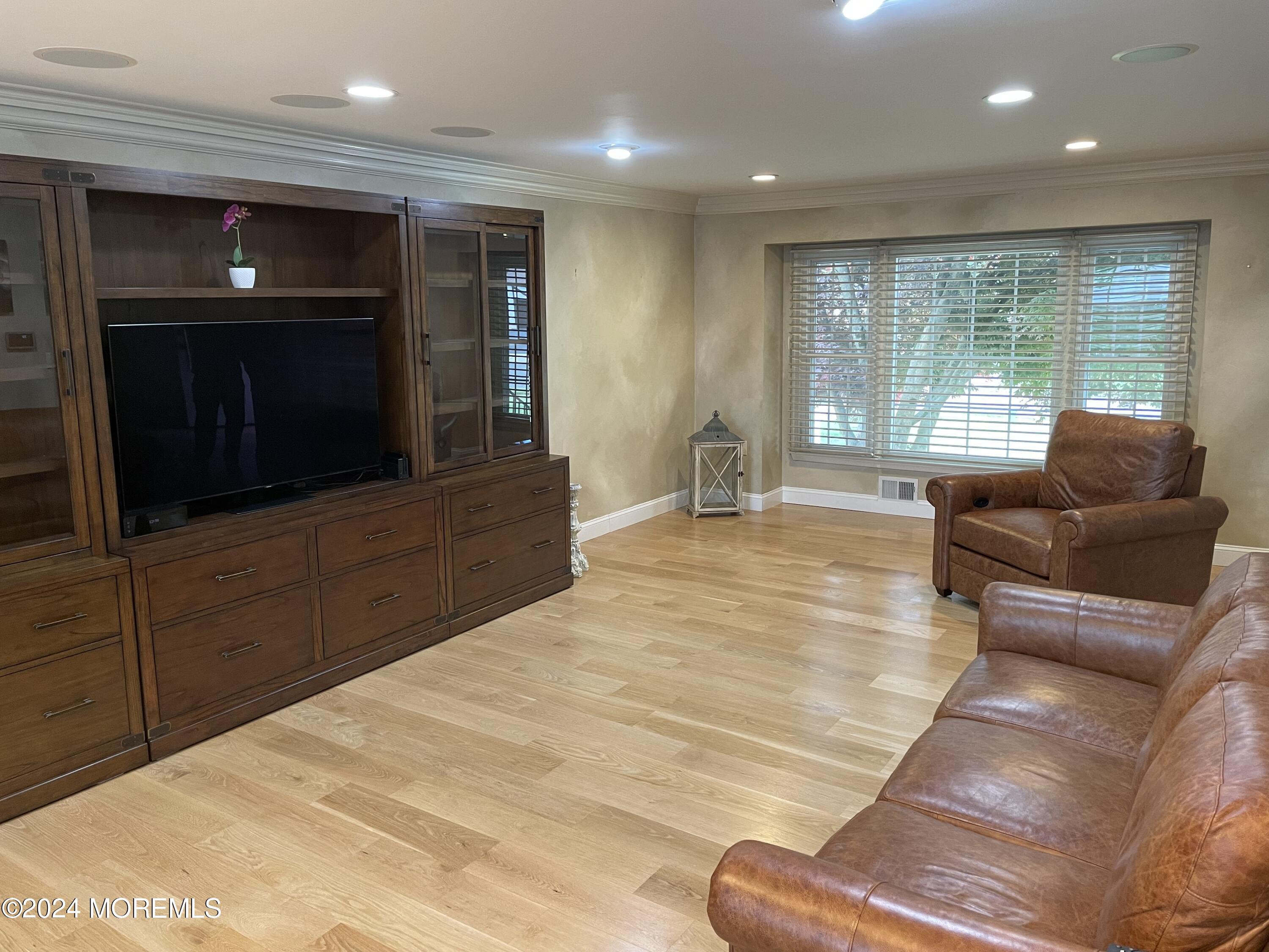 1 Longstreet Road Manalapan, NJ 07726 - Photo 18 of 76 a living room with furniture and a flat screen tv
