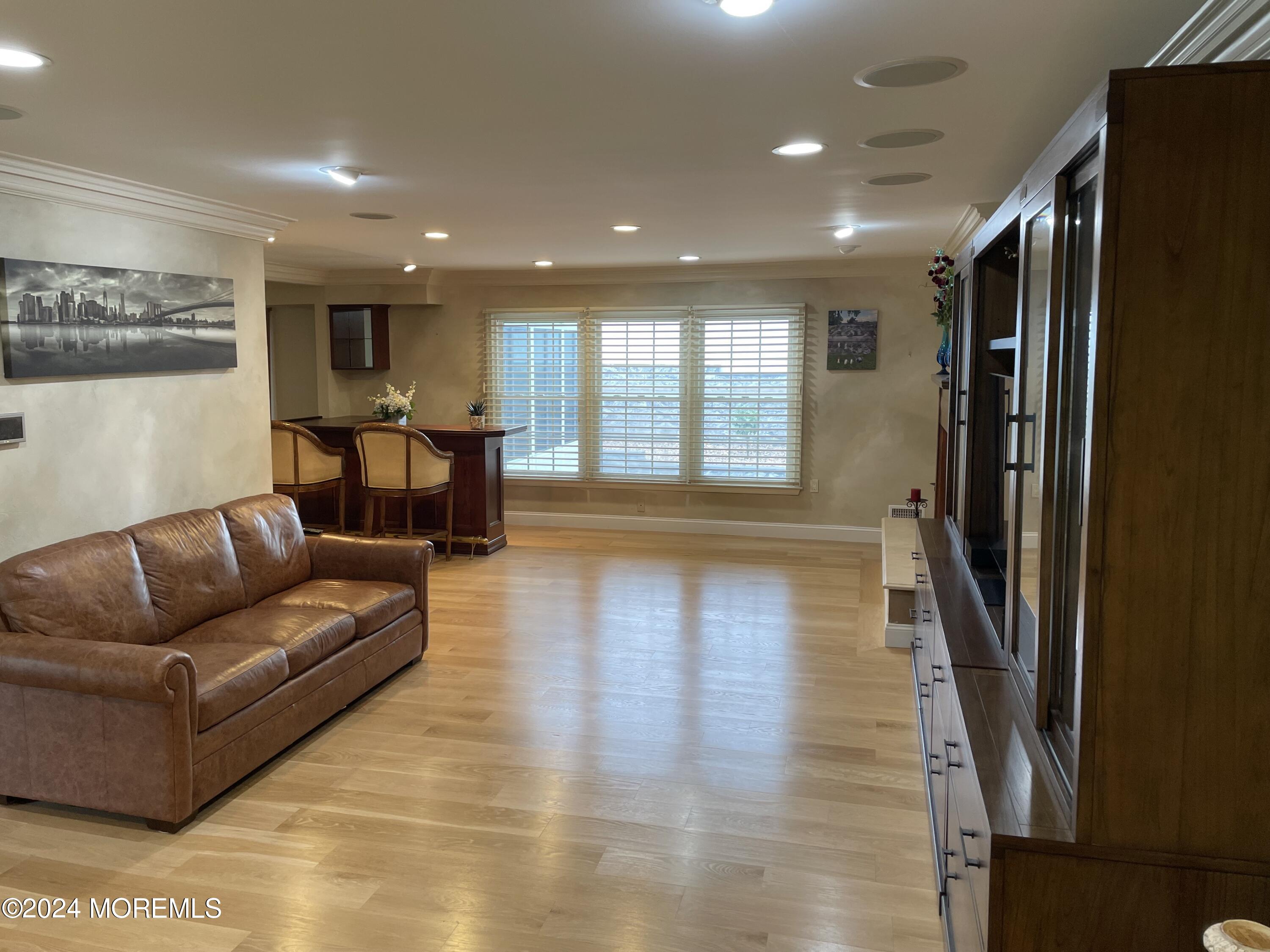1 Longstreet Road Manalapan, NJ 07726 - Photo 19 of 76 a living room with furniture and a wooden floor