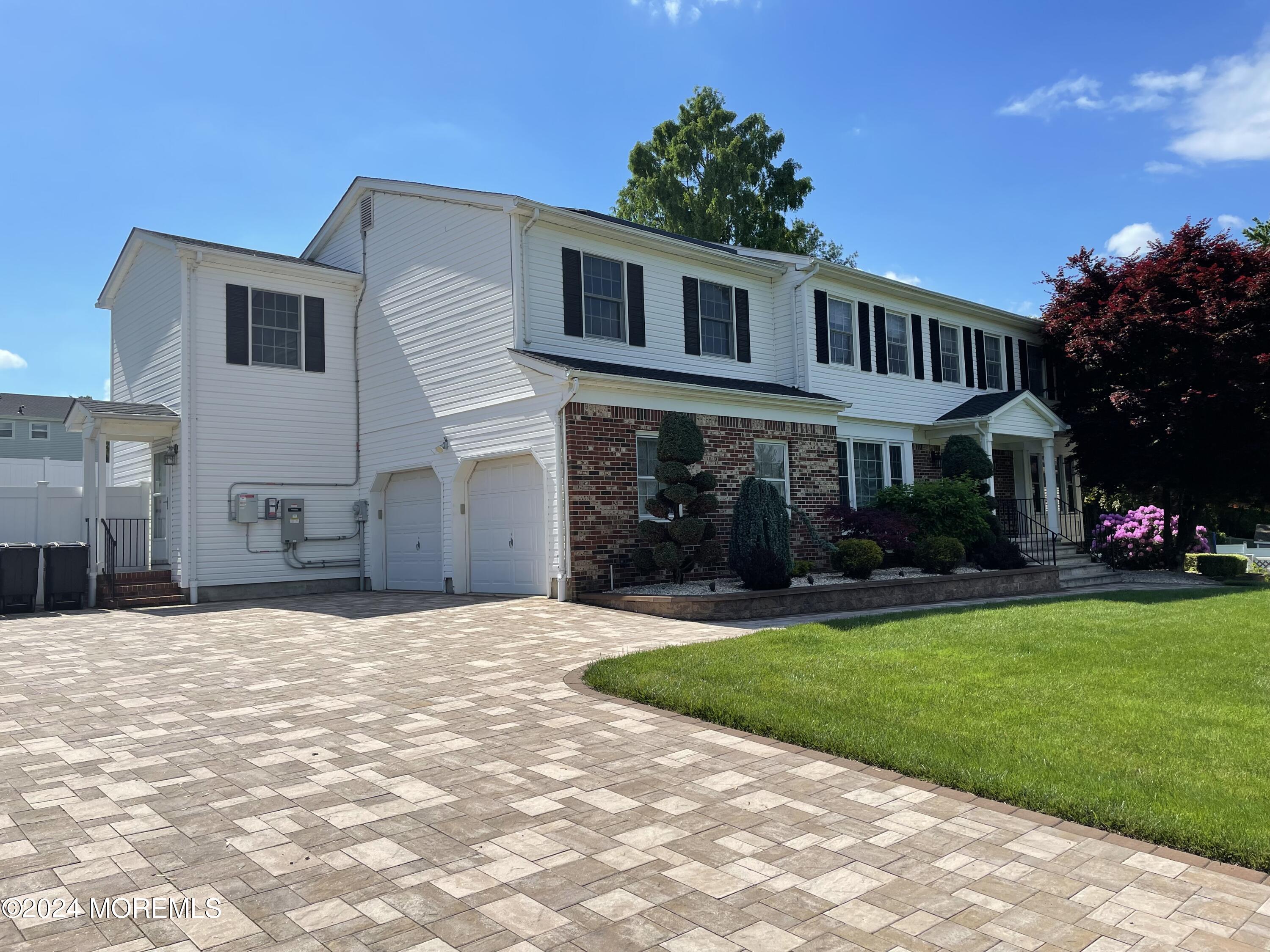 1 Longstreet Road Manalapan, NJ 07726 - Photo 2 of 76 a front view of a house with a yard and garage