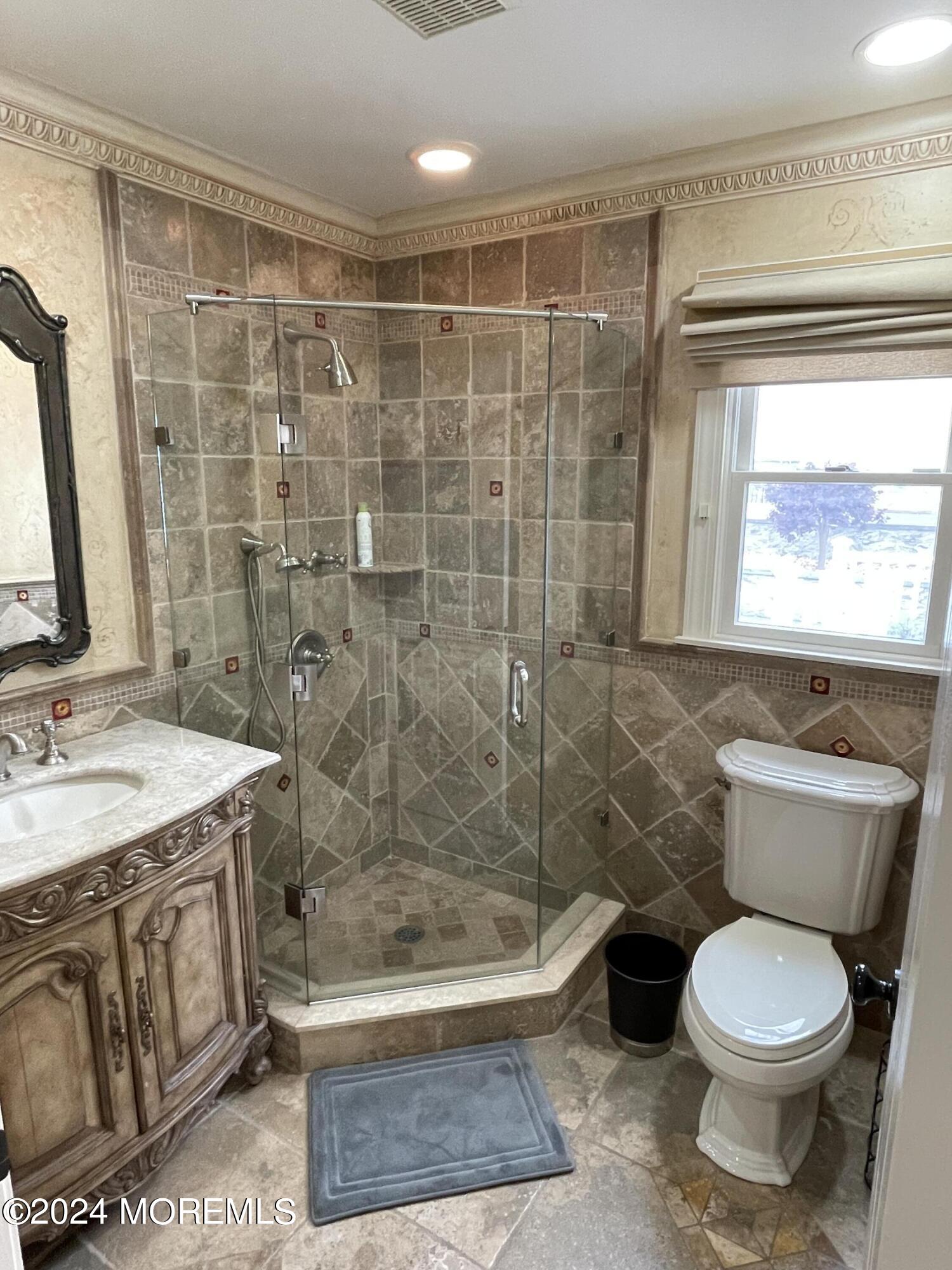 1 Longstreet Road Manalapan, NJ 07726 - Photo 23 of 76 a bathroom with a granite countertop toilet a sink a mirror a bathtub and shower