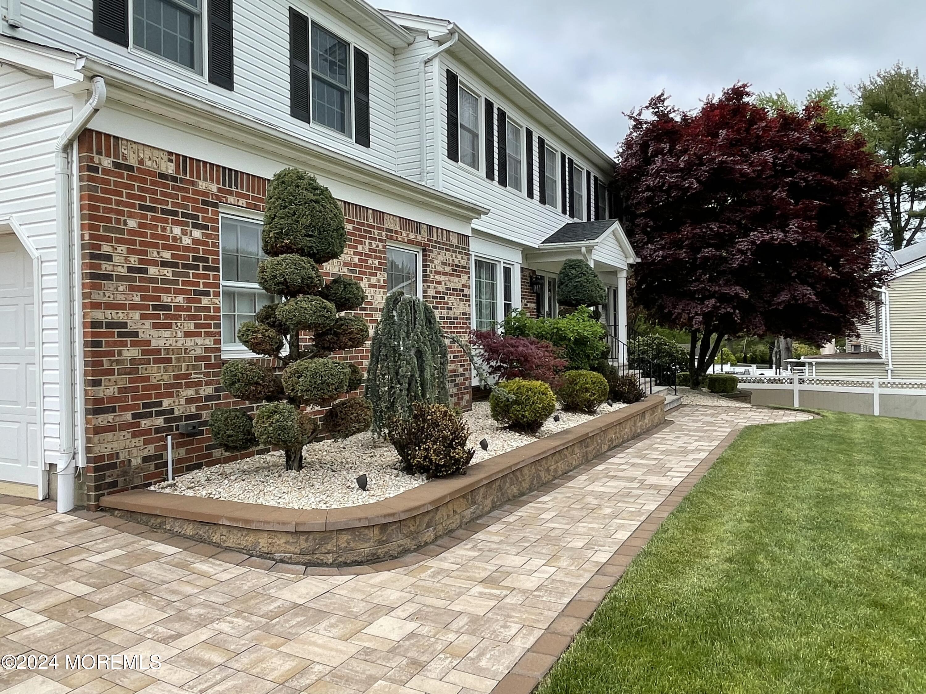 1 Longstreet Road Manalapan, NJ 07726 - Photo 3 of 76 a view of a house with fountain and plants