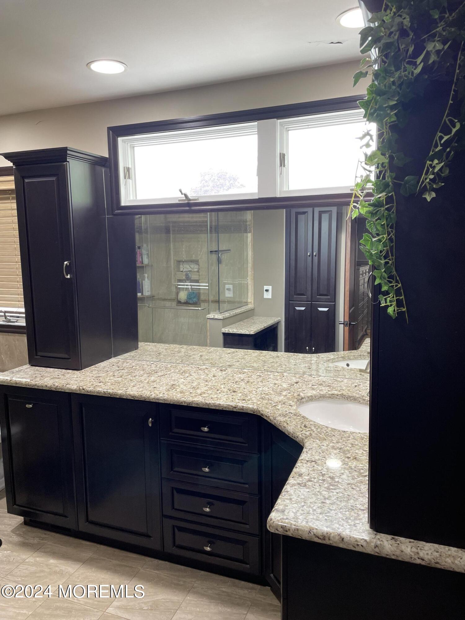 1 Longstreet Road Manalapan, NJ 07726 - Photo 32 of 76 a bathroom with a granite countertop sink and a mirror