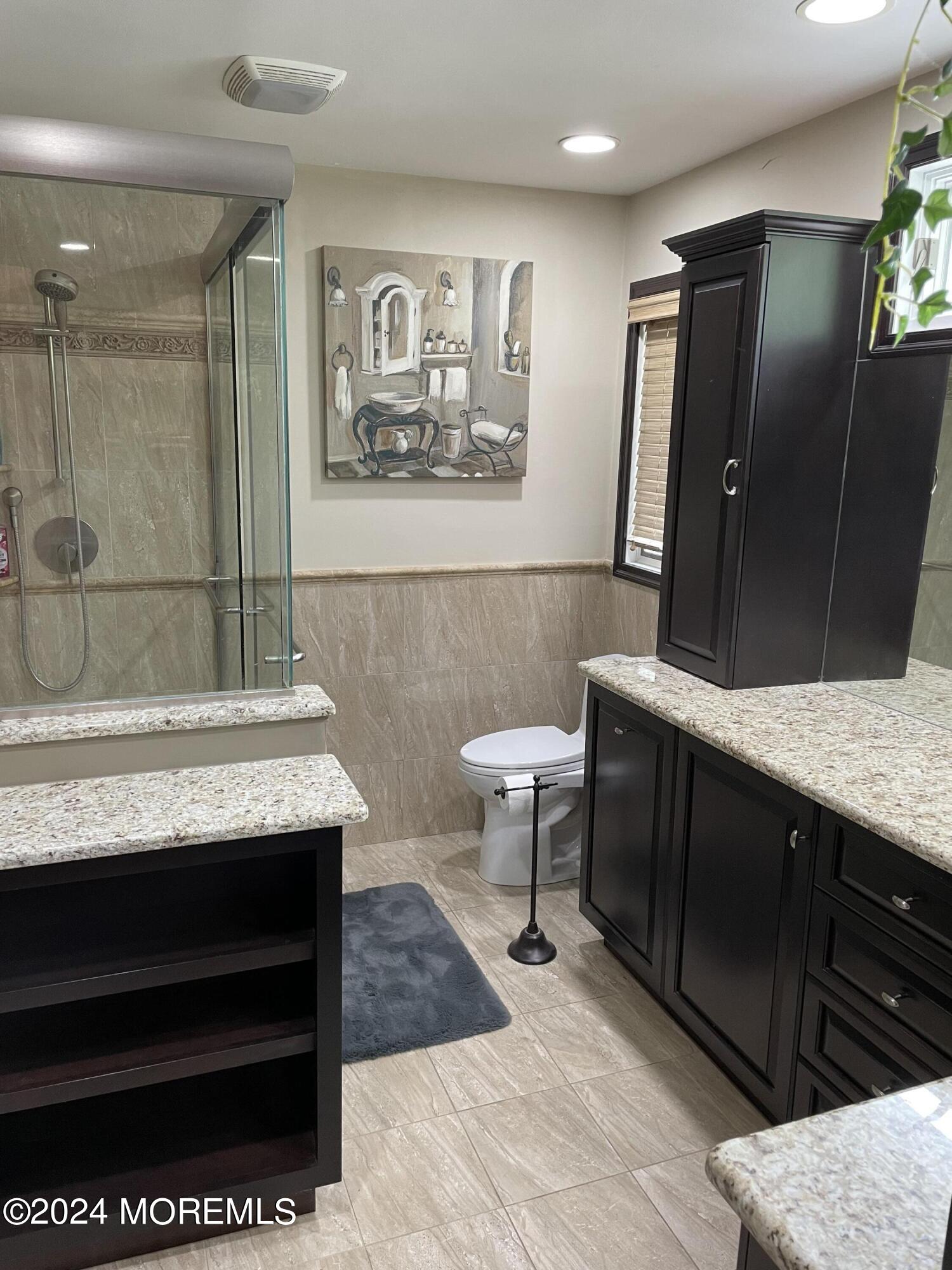 1 Longstreet Road Manalapan, NJ 07726 - Photo 33 of 76 a bathroom with a granite countertop sink a mirror and a toilet