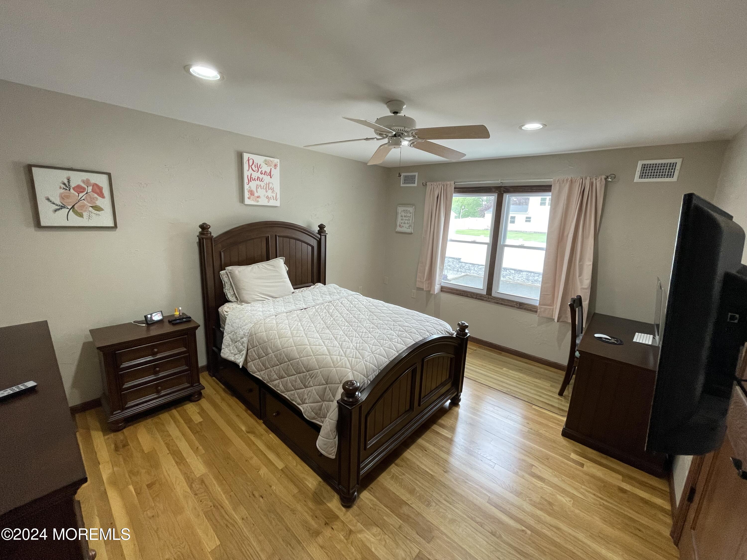 1 Longstreet Road Manalapan, NJ 07726 - Photo 38 of 76 a bedroom with a bed and wooden floor