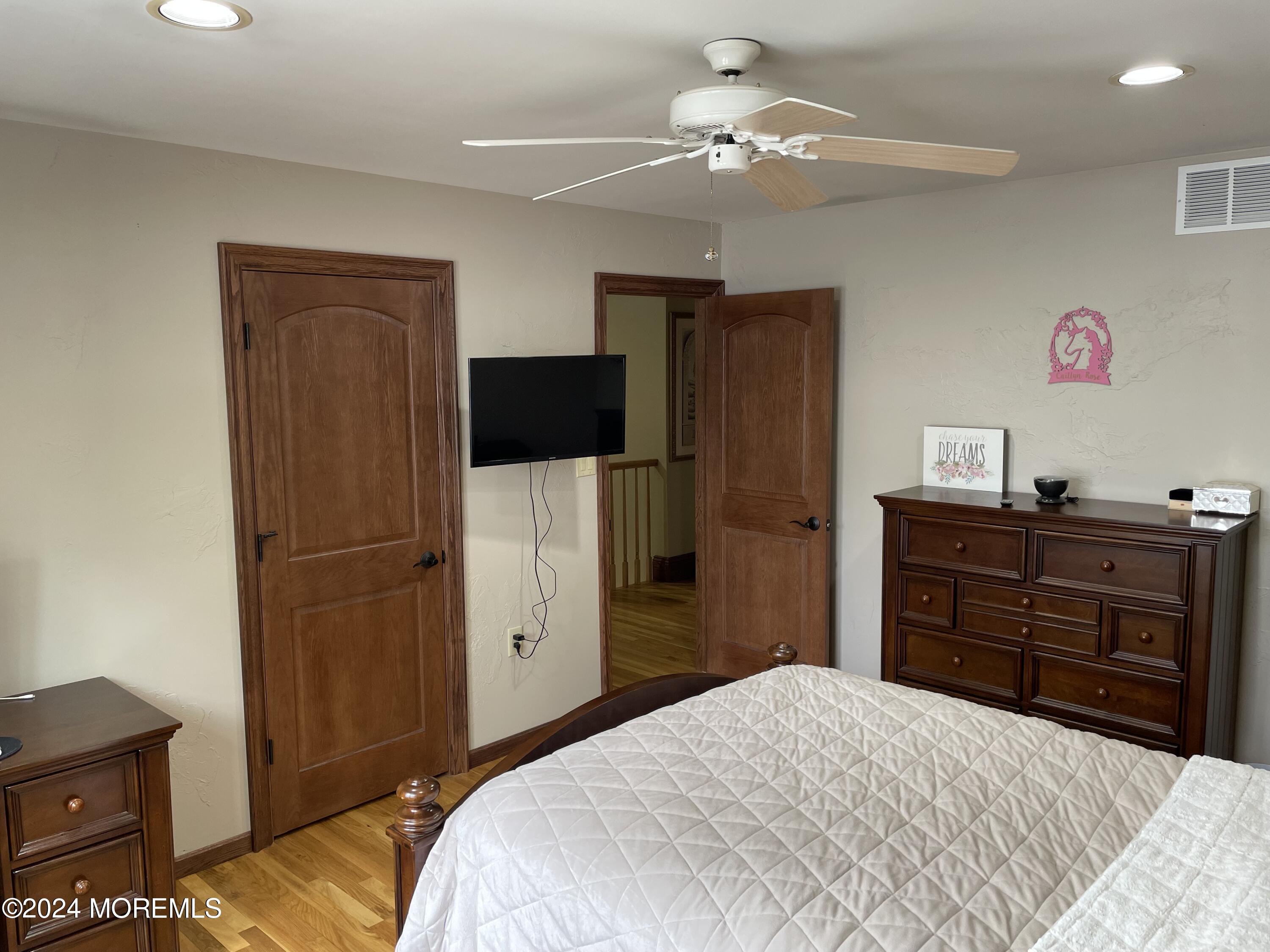 1 Longstreet Road Manalapan, NJ 07726 - Photo 40 of 76 a bedroom with a bed and wooden floor