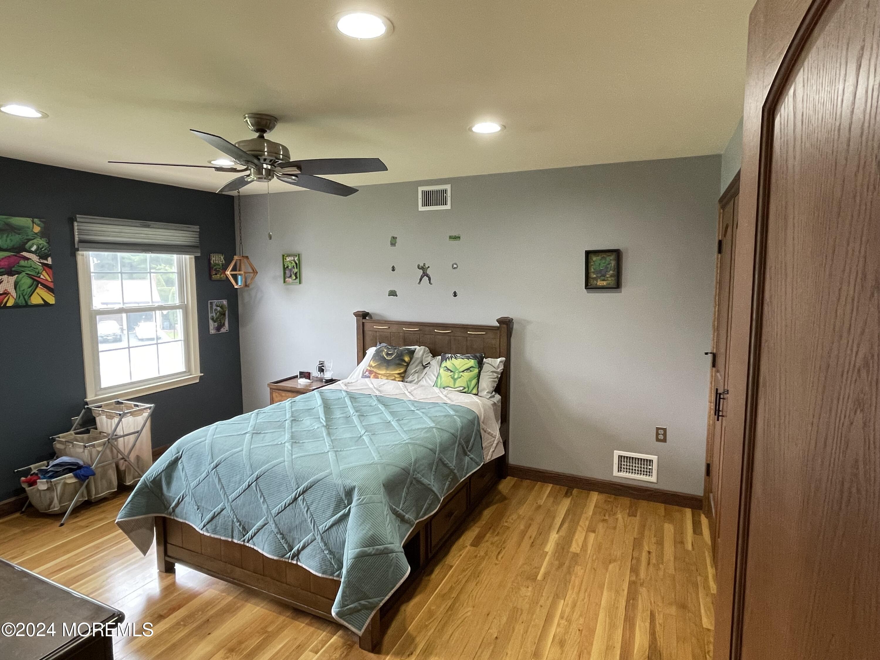 1 Longstreet Road Manalapan, NJ 07726 - Photo 41 of 76 a bedroom with a bed and wooden floor
