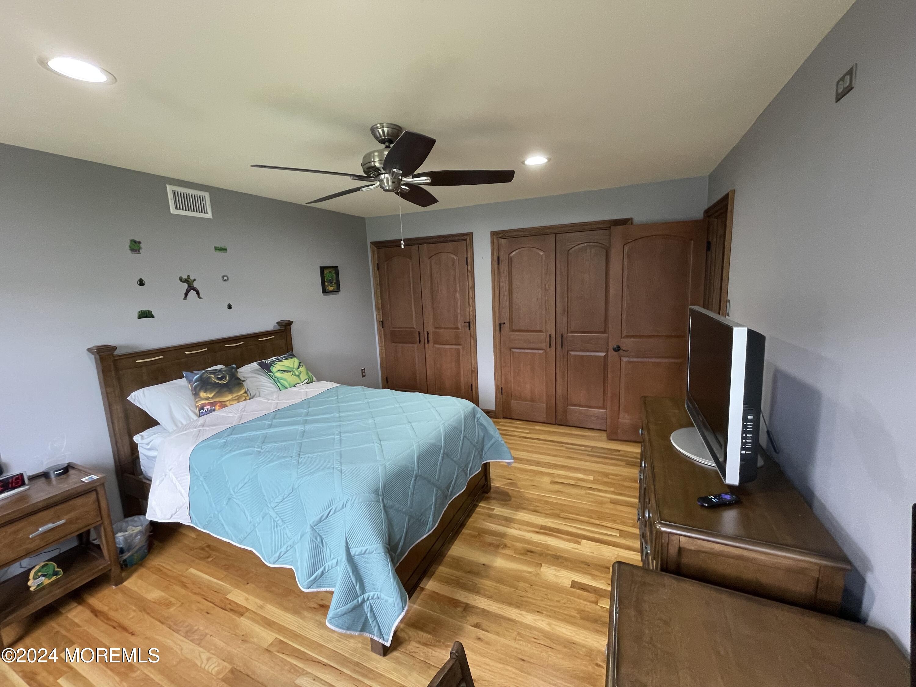 1 Longstreet Road Manalapan, NJ 07726 - Photo 42 of 76 a bedroom with a bed and a flat tv screen on the dresser
