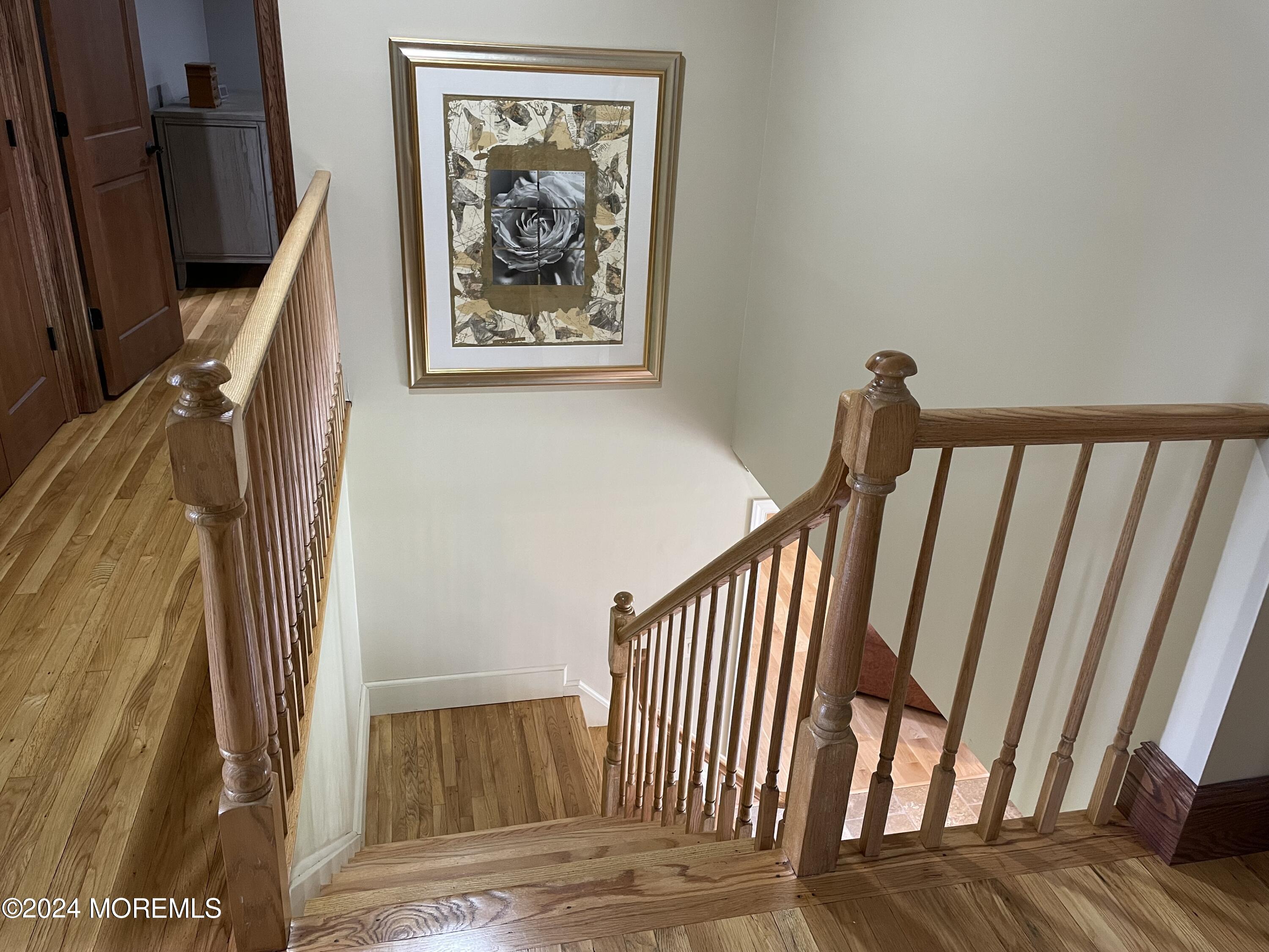 1 Longstreet Road Manalapan, NJ 07726 - Photo 46 of 76 a view of staircase with wooden floor and a rug