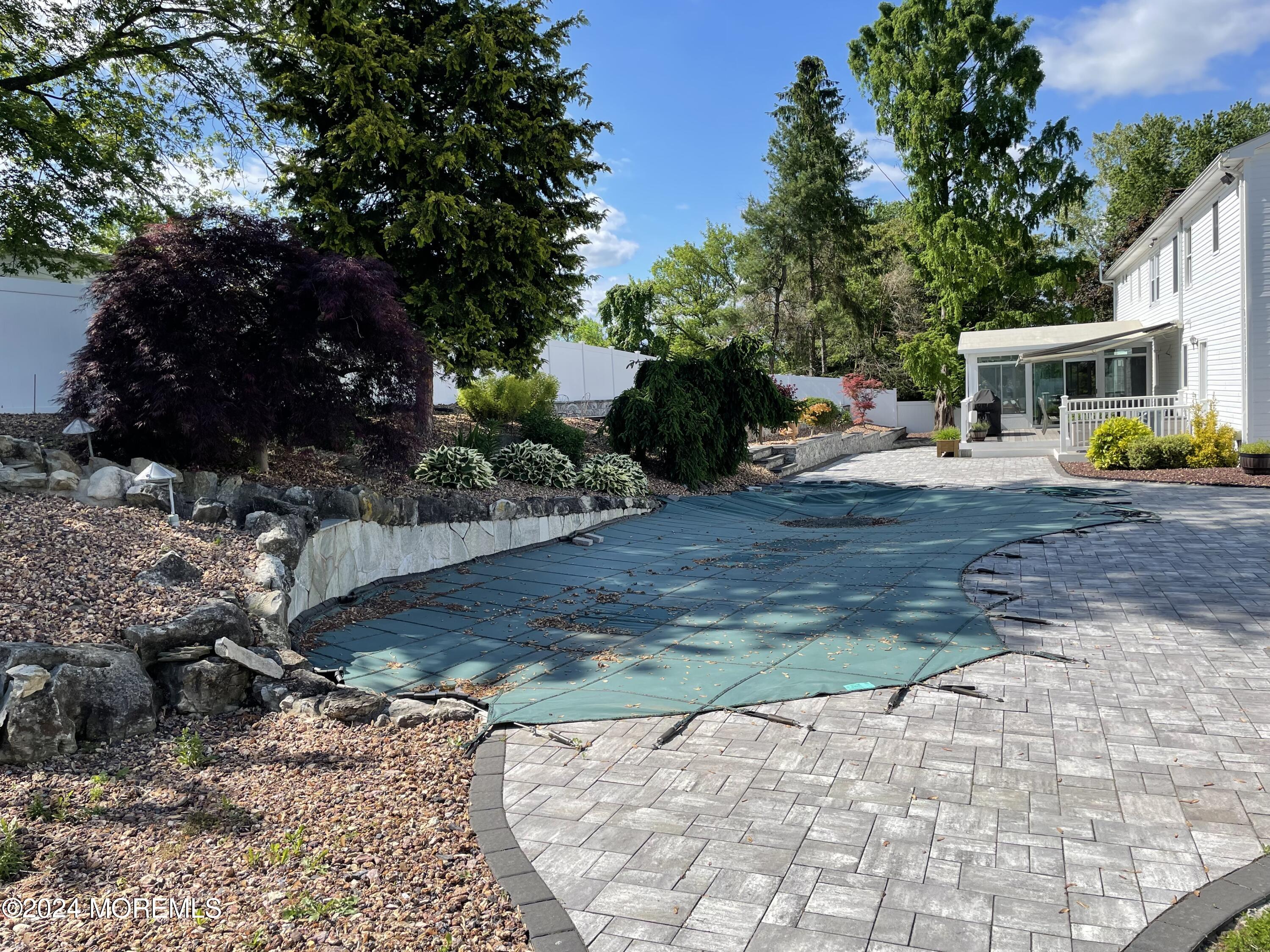 1 Longstreet Road Manalapan, NJ 07726 - Photo 73 of 76 a view of a backyard with table and chairs plants and trees