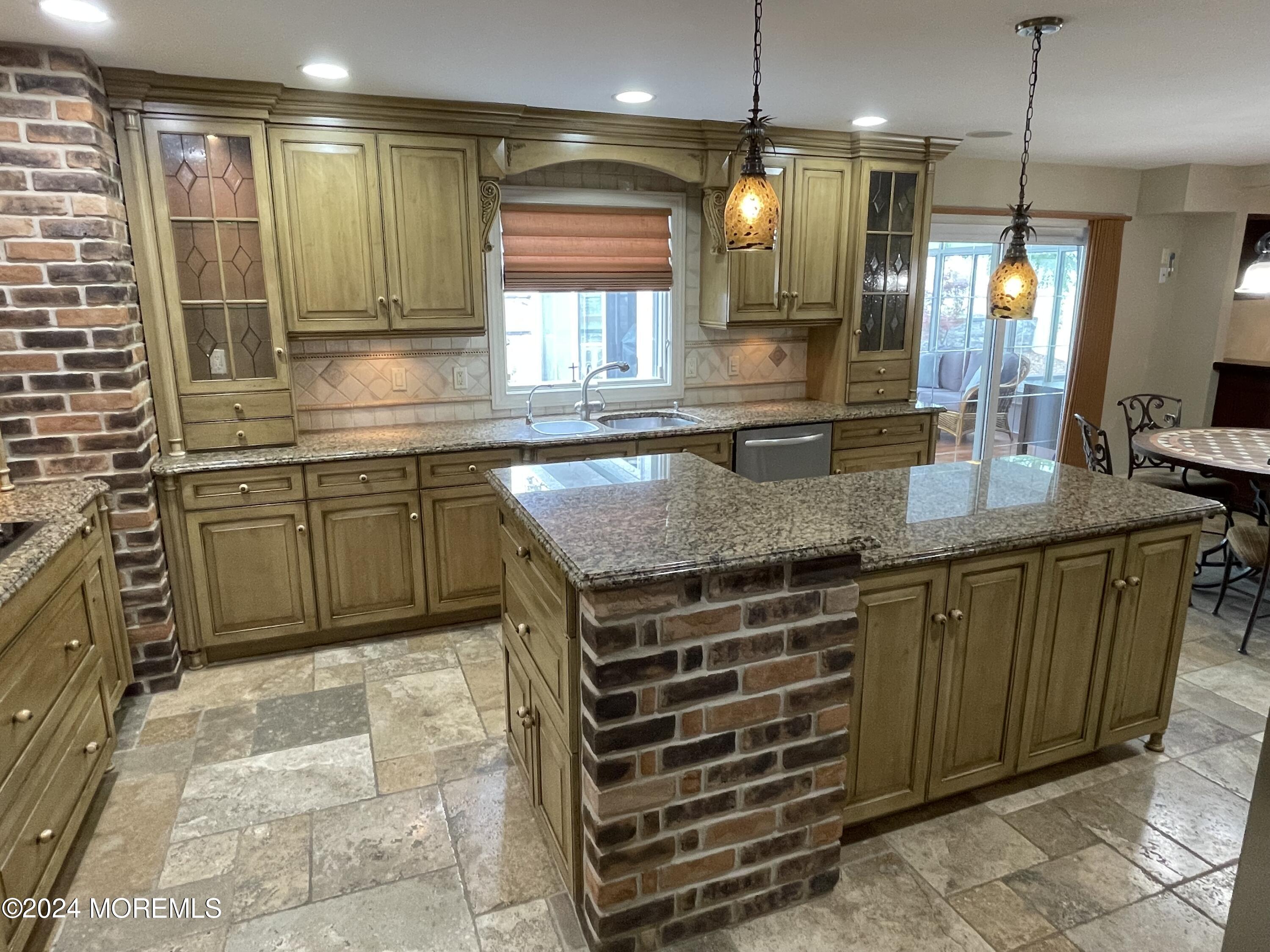1 Longstreet Road Manalapan, NJ 07726 - Photo 10 of 76 a kitchen with kitchen island granite countertop a sink a counter top space appliances and cabinets